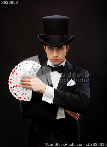 Image of magician showing trick with playing cards