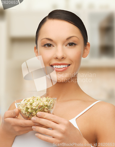 Image of healthy woman holding bowl with sprout