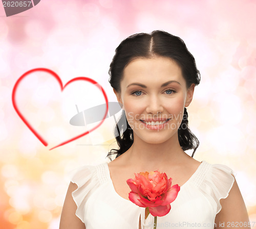 Image of young and beautiful woman with flower