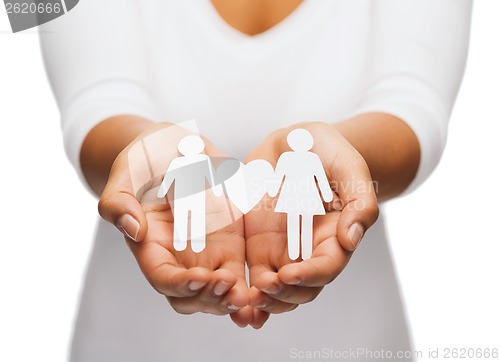 Image of womans hands with paper couple