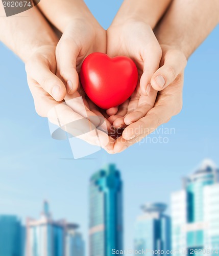 Image of woman and man hands with heart
