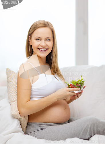 Image of happy pregnant woman with bowl of salad