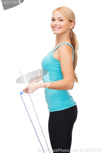 Image of sporty woman with with skipping rope