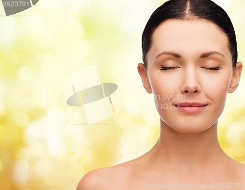 Image of young calm woman with closed eyes
