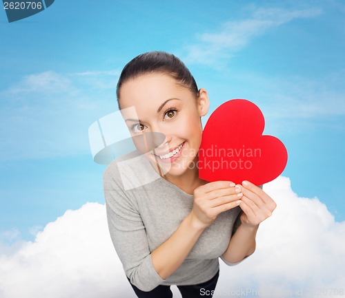 Image of smiling asian woman with red heart