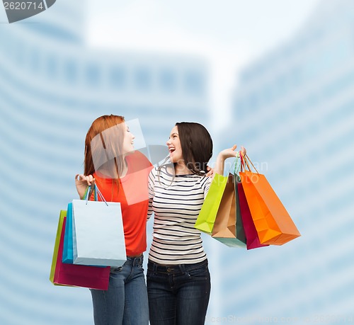 Image of two smiling teenage girls with shopping bags