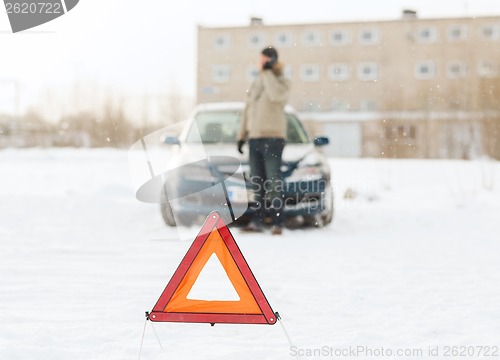 Image of closeup of man with broken car and smartphone