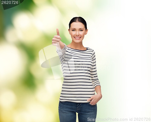 Image of smiling girl in casual clother showing thumbs up