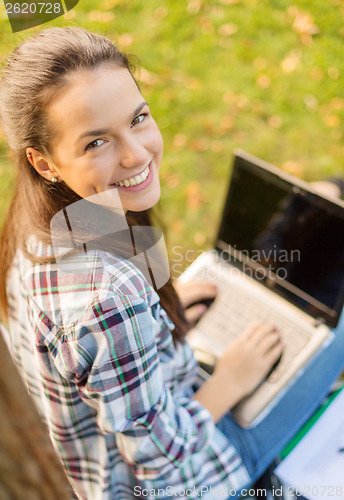 Image of smiling teenager with laptop