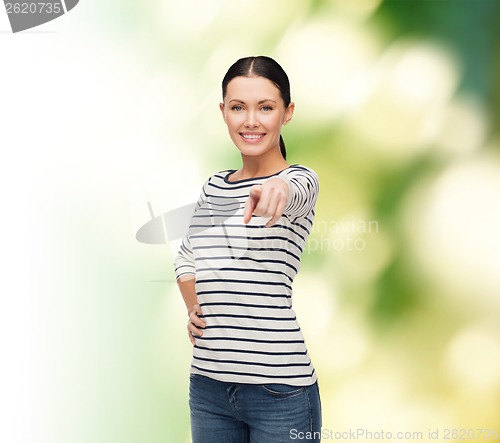 Image of smiling girl in casual clother pointing at you