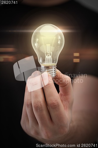 Image of close up of man hand holding light bulb