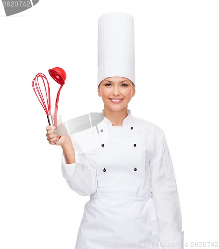 Image of smiling female chef with cooking equipment