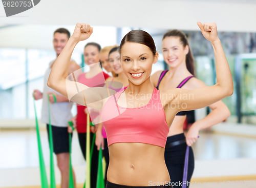 Image of personal trainer with group in gym