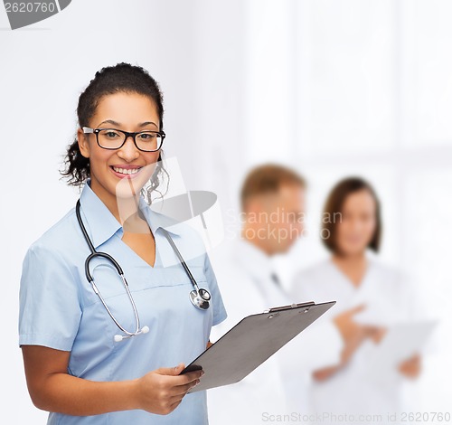 Image of smiling female african american doctor or nurse