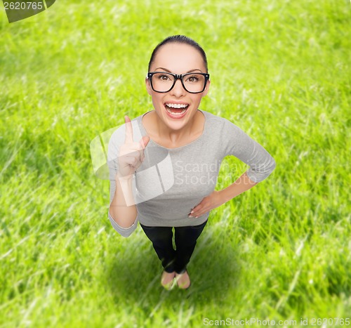Image of asian woman in eyeglasses with finger up