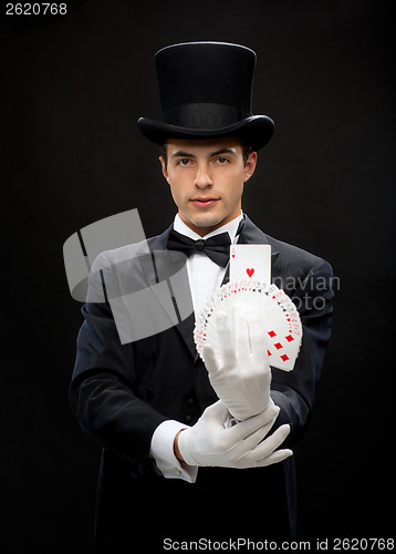 Image of magician showing trick with playing cards