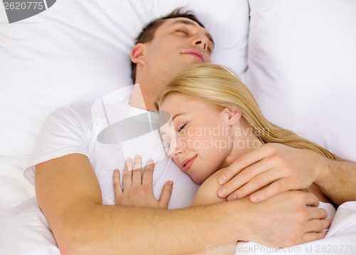 Image of happy couple sleeping in bed