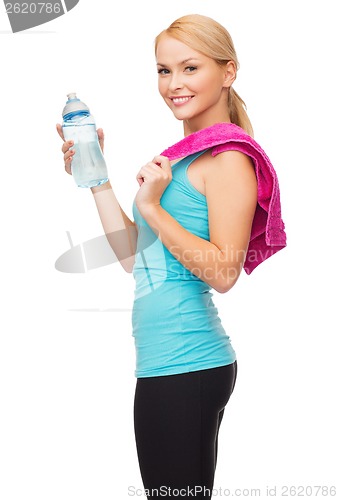 Image of sporty woman with towel and watel bottle