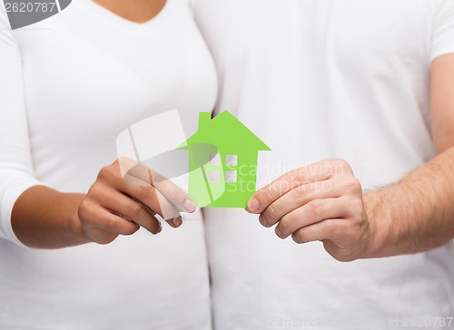 Image of couple hands holding green house