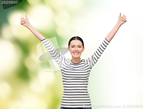Image of smiling girl in casual clother showing thumbs up