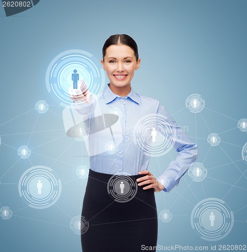 Image of smiling businesswoman pointing finger at you