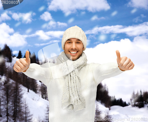 Image of handsome man in warm sweater, hat and scarf