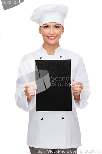 Image of smiling female chef with black blank paper
