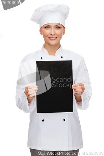 Image of smiling female chef with black blank paper