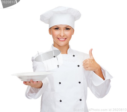 Image of female chef with empty plate showing thumbs up