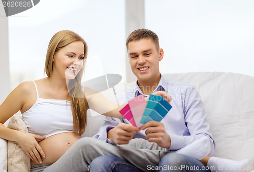 Image of expecting parents choosing color for nursery