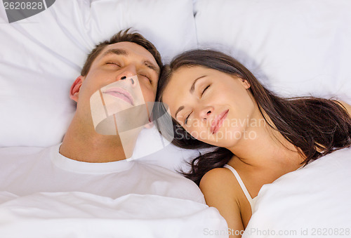 Image of happy couple sleeping in bed