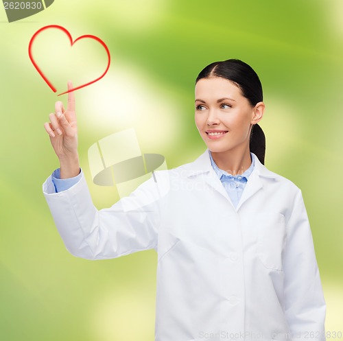 Image of smiling female doctor pointing to heart