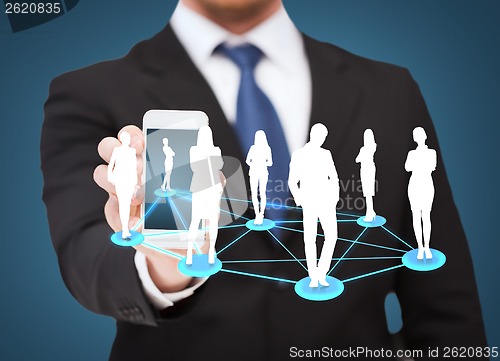 Image of businessman showing smartphone with social network