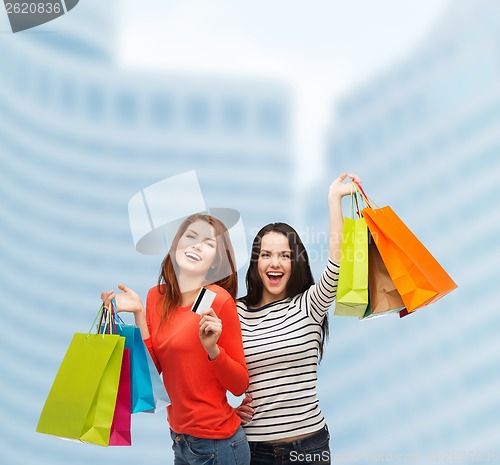 Image of teenage girls with shopping bags and credit card