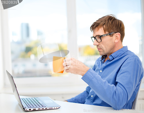 Image of man working with laptop at home