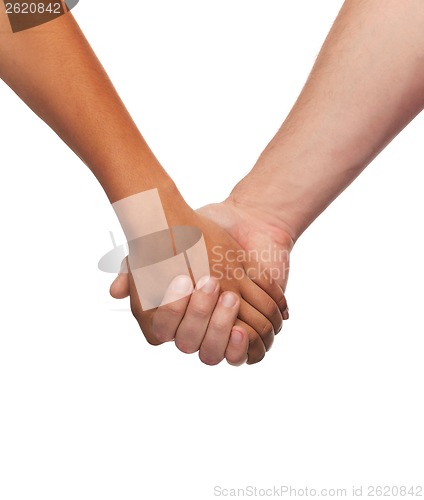 Image of woman and man holding hands