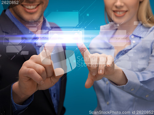 Image of man and woman hands pointing at virtual screen