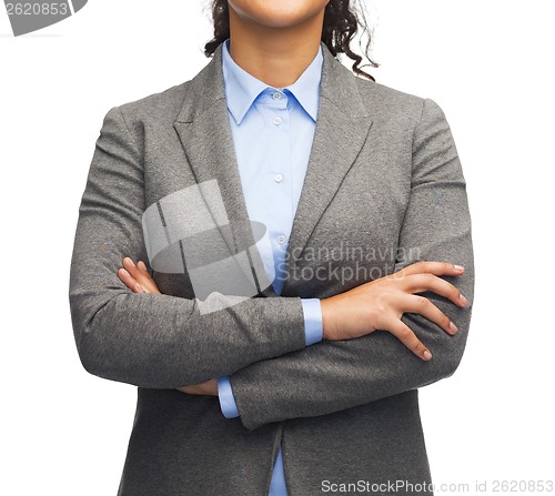 Image of smiling businesswoman with crossed arms