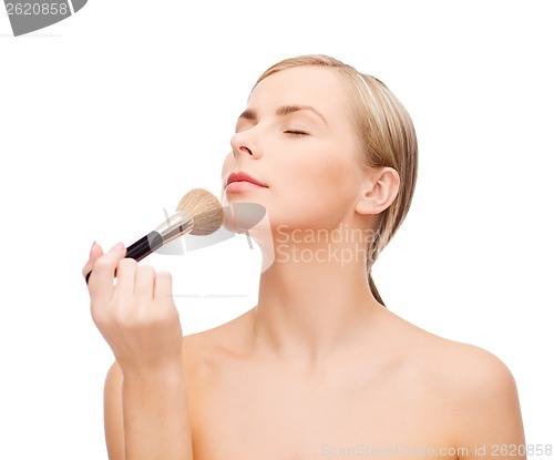 Image of beautiful woman with makeup brush