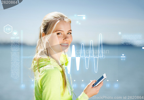 Image of woman listening to music outdoors