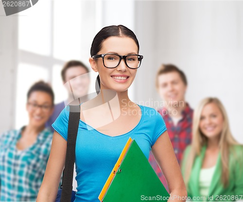 Image of smiling student with bag and folders
