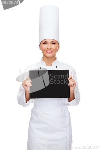 Image of smiling female chef with black blank paper