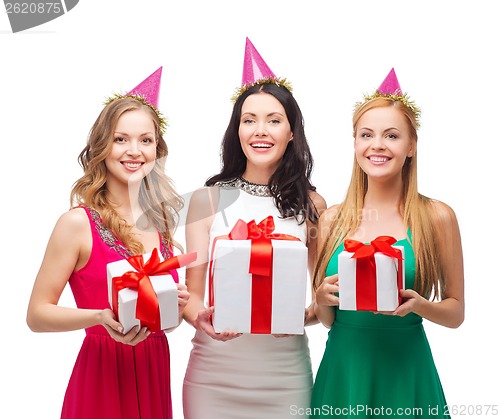 Image of three smiling women in blue hats with gift boxes