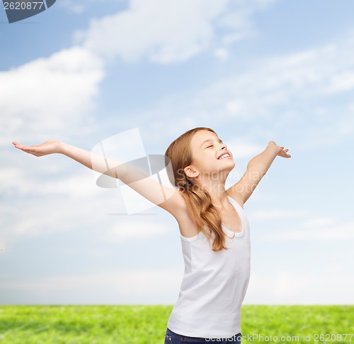 Image of smiling teenage girl with raised hands