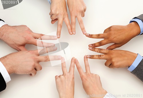 Image of group of businesspeople showing v-sign