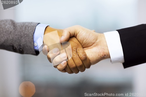 Image of businessman and businesswoman shaking hands