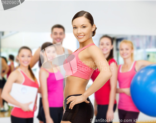 Image of personal trainer with group in gym