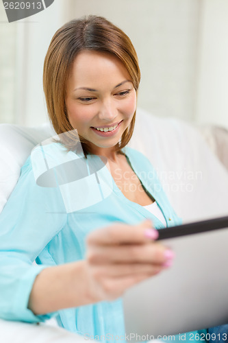 Image of happy woman with tablet pc computer at home