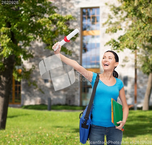 Image of smiling student with bag and folders