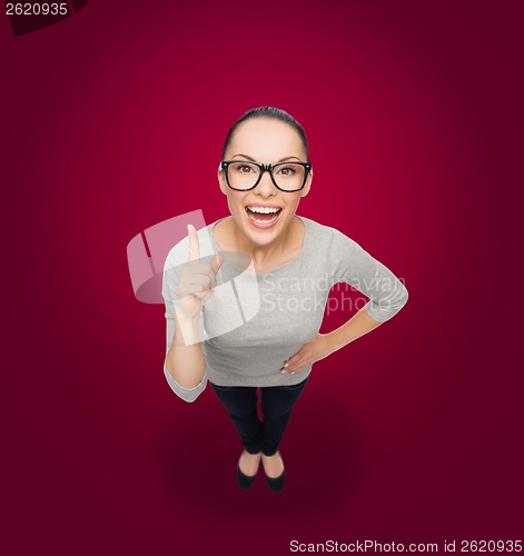 Image of asian woman in eyeglasses with finger up